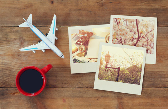 travel instant photographs next to cup of coffee and airplane