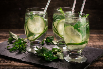 detox water with a lemon, lime and mint on a wooden table