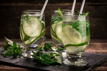 detox water with a lemon, lime and mint on a wooden table