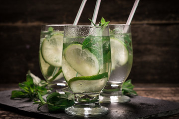 detox water with a lemon, lime and mint on a wooden table