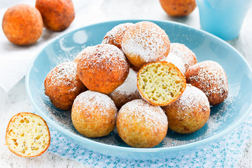 Homemade sponge donuts with powdered sugar