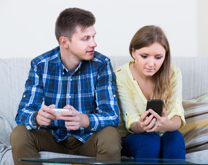 couple addicted to social networking with cell phones