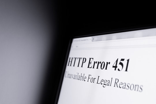 HTTP error 451 Unavailable For Legal Reasons - Shining computer screen in dark space - censorship and blocking internet pages because of objectionable content.