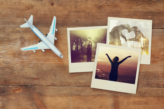 travel instant photographs next to airplane over wooden table
