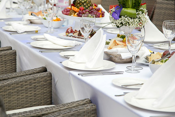 Beautifully decorated table in the restaurant. Fresh flowers and fruit.
