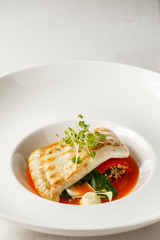 Grilled turbot, tabouli, sweet pepper sauce and summer vegetables. White dish