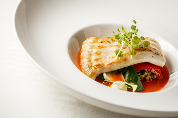 Grilled turbot, tabouli, sweet pepper sauce and summer vegetables. White dish