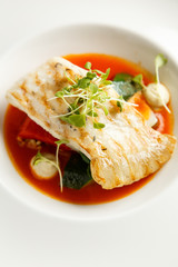Grilled turbot, tabouli, sweet pepper sauce and summer vegetables. White dish