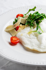 Fluffy Egg White Omelette with rukola, cheese and cherry tomatoes. White dish. Without yolk.