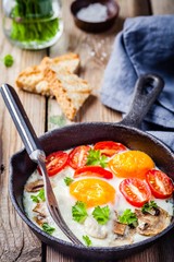 breakfast: fried eggs with tomatoes and mushrooms