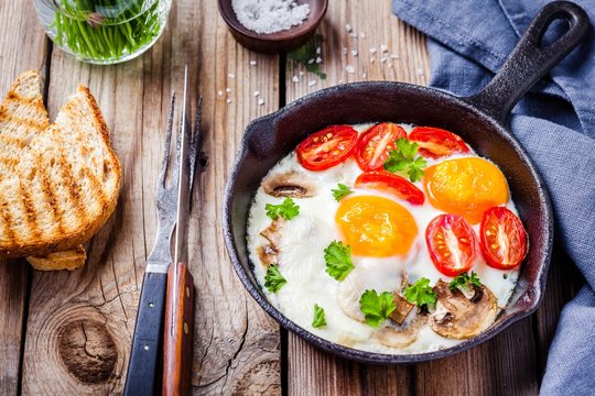 breakfast: fried eggs with tomatoes and mushrooms