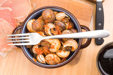 metal pot with snails cooked