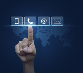 Hand pressing telephone, mobile phone, at and email buttons over