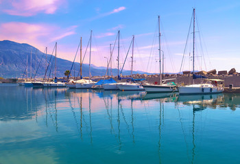 Fototapeta na wymiar sunset boats reflection at Kalamata harbor Peloponnese Greece