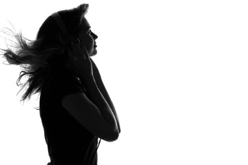 silhouette of a woman with headphones