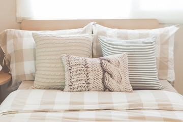 set of pillows on modern bed in modern bedroom