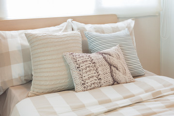 set of pillows on modern bed in modern bedroom