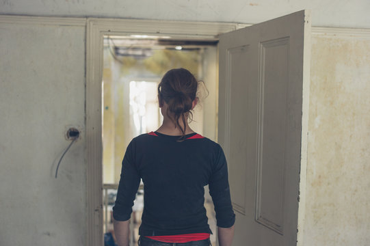 Woman standing by door in house being renovated