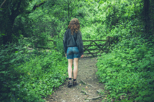 Young woman standing in forest