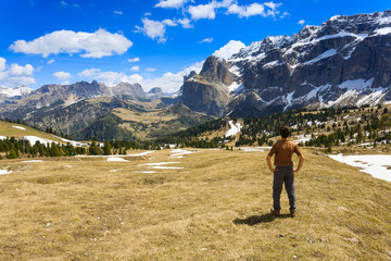 Man on top of mountain looking at the horizon.