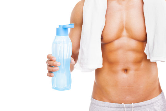 Fit man holding a bottle of water, isolated on white background