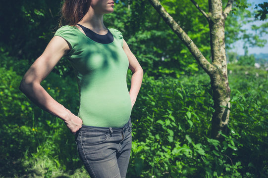 Young pregnant woman in the woods