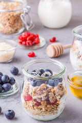 Healthy breakfast - glass jars of oat flakes with fresh fruit.