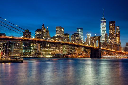 Fototapeta Manhattan with skyscrapers and  Brooklin Bridge by evening, New
