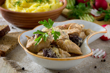 Traditional hot ragout with meat and prunes stewed in sour cream