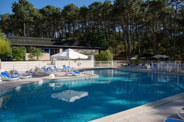 Backyard with swimming pool and patio area.