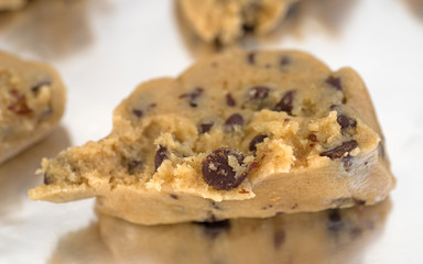 Chocolate chip cookie dough on tinfoil close view.