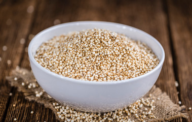 Puffed Quinoa (selective focus; close-up shot) on wooden backgro