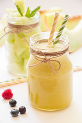 Melon smoothie and salad in 2 jars.