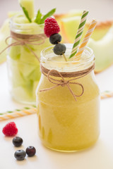 Melon smoothie and salad in 2 jars.