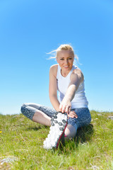 Fototapeta premium Young sports woman enjoys fitness and bright sunshine
