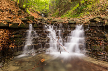 Fototapeta na wymiar Waterfall on Mosorny creek, Beskid Zywiecki mountain range in Polish Carpathian Mountains