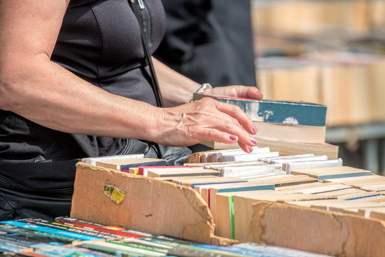 Second Hand Book Stall. Woman Buying Books