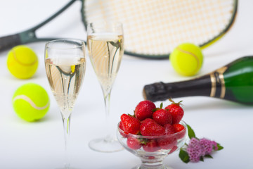Strawberries and champagne, tennis racket and balls in background