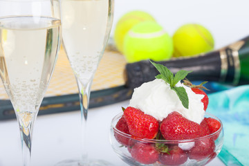  Strawberries with whipped cream and mint leaves and glasses with champagne 