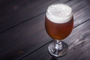 Amber ale on dark wood