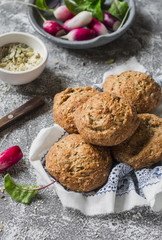 Homemade whole wheat rolls and fresh vegetables on a grey stone background