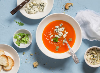 Pumpkin soup with blue cheese on a blue stone background. Healthy food