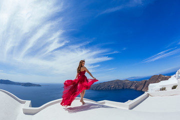 Woman in red dress l on the roof