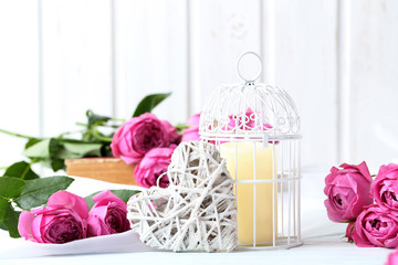 Beautiful pink roses on a white wooden table