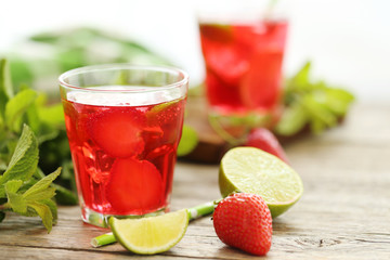 Fresh strawberry drink in glass on wooden table