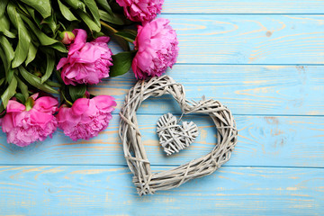 Bouquet of pink peony flowers on wooden table