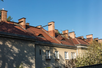 Chimneys on the roofs of old houses fitted with heating stoves.