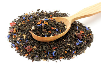 Fruit and flowers petals black tea in spoon