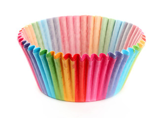 Colourful rainbow paper baking cases isolated on white