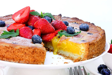 Summer berry fruit tart dessert with lemon curd cream